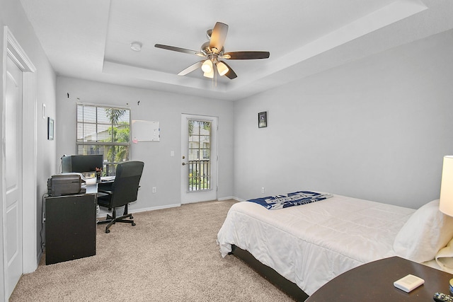 2186 SE Destin Dr, Port Saint Lucie, FL 34952 - bedroom with a raised ceiling, carpet floors, an office area, baseboards, and a ceiling fan