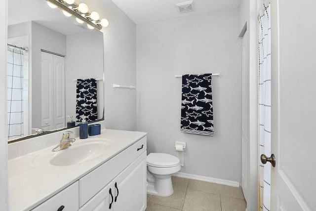 2186 SE Destin Dr, Port Saint Lucie, FL 34952 - full bathroom with vanity, toilet, tile patterned flooring, and baseboards