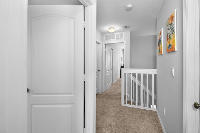 2186 SE Destin Dr, Port Saint Lucie, FL 34952 - hall with an upstairs landing, carpet floors, a textured ceiling, and baseboards