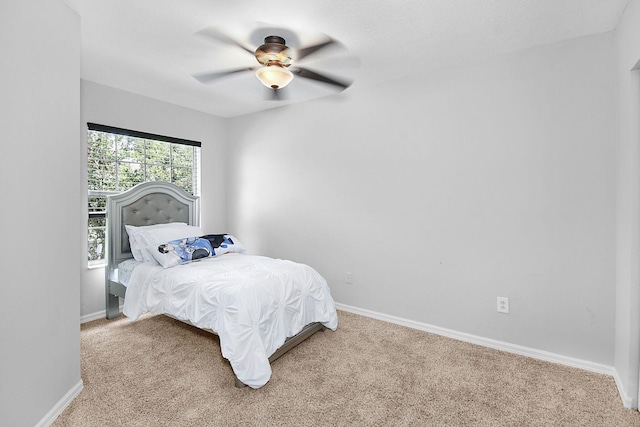 2186 SE Destin Dr, Port Saint Lucie, FL 34952 - bedroom featuring light colored carpet, baseboards, and a ceiling fan