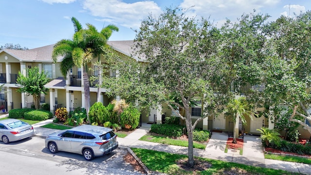 2186 SE Destin Dr, Port Saint Lucie, FL 34952 - view of front facade featuring stucco siding and roof with shingles