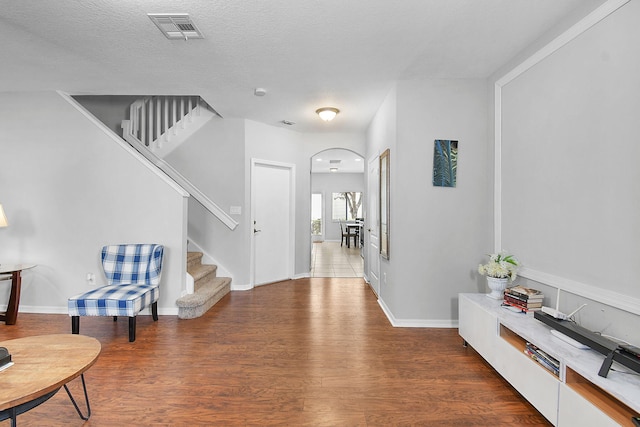 2186 SE Destin Dr, Port Saint Lucie, FL 34952 - foyer with stairs, wood finished floors, arched walkways, and baseboards