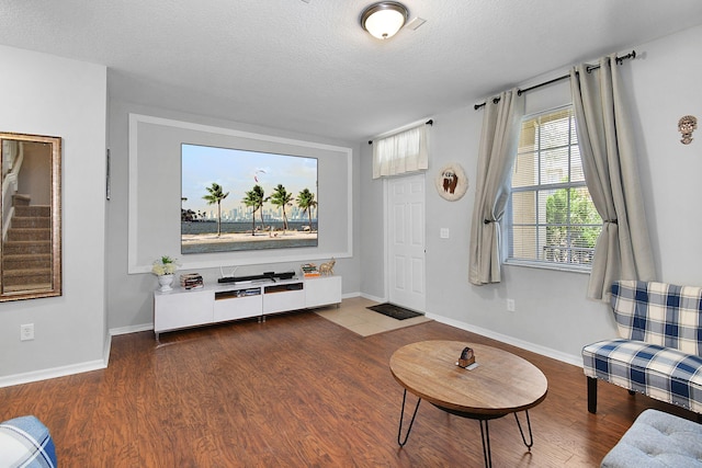 2186 SE Destin Dr, Port Saint Lucie, FL 34952 - living room with wood finished floors, a textured ceiling, baseboards, and stairway