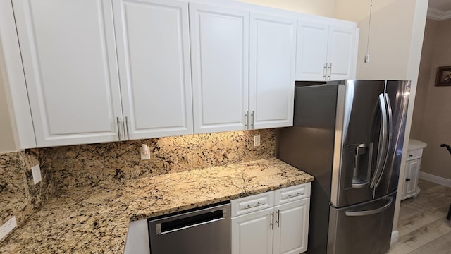 9587 Weldon Cir Unit B414, Tamarac, FL 33321 - kitchen with stainless steel appliances, white cabinetry, tasteful backsplash, and light wood finished floors