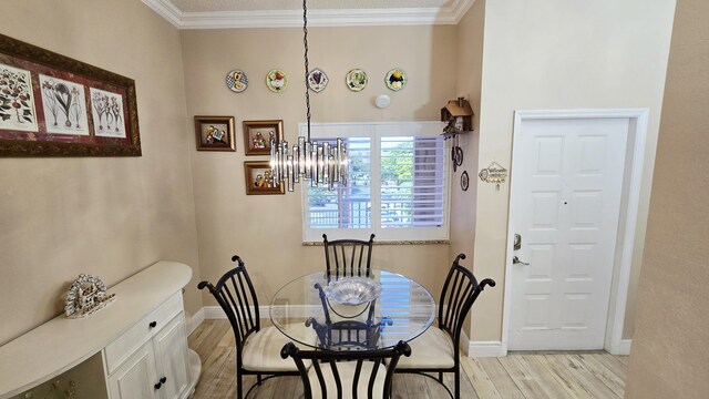 9587 Weldon Cir Unit B414, Tamarac, FL 33321 - dining space featuring light wood-type flooring, ornamental molding, baseboards, and a chandelier