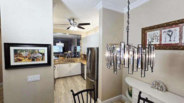 9587 Weldon Cir Unit B414, Tamarac, FL 33321 - kitchen with a sink, a ceiling fan, white cabinetry, crown molding, and freestanding refrigerator