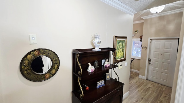 9587 Weldon Cir Unit B414, Tamarac, FL 33321 - foyer with crown molding, light wood finished floors, a textured ceiling, and baseboards