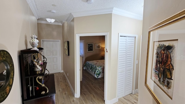 9587 Weldon Cir Unit B414, Tamarac, FL 33321 - corridor featuring light wood-type flooring, a textured ceiling, crown molding, and baseboards