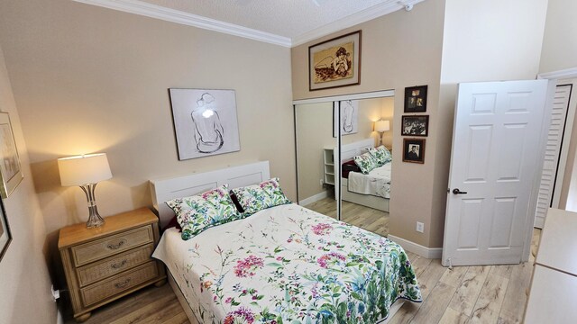 9587 Weldon Cir Unit B414, Tamarac, FL 33321 - bedroom with ornamental molding, light wood-type flooring, a closet, and baseboards