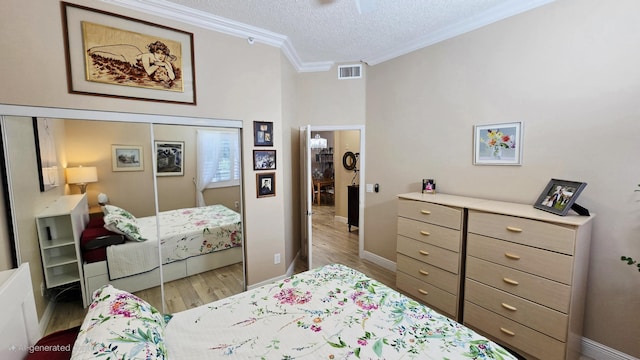 9587 Weldon Cir Unit B414, Tamarac, FL 33321 - bedroom featuring wood finished floors, a textured ceiling, ornamental molding, and baseboards