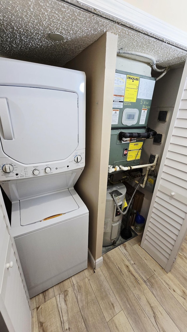 9587 Weldon Cir Unit B414, Tamarac, FL 33321 - laundry room featuring stacked washer / drying machine and wood finished floors