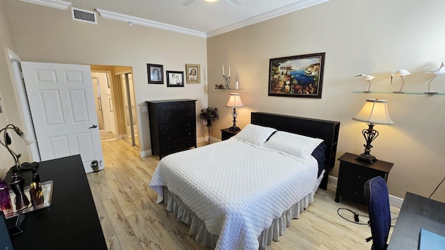 9587 Weldon Cir Unit B414, Tamarac, FL 33321 - bedroom with light wood finished floors, crown molding, baseboards, and a textured ceiling