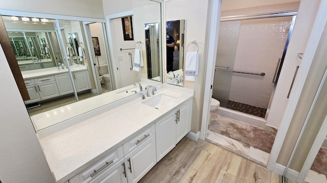 9587 Weldon Cir Unit B414, Tamarac, FL 33321 - full bathroom with toilet, a stall shower, vanity, baseboards, and wood finished floors