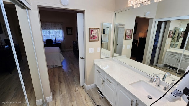 9587 Weldon Cir Unit B414, Tamarac, FL 33321 - bathroom featuring ensuite bath, wood finished floors, and vanity