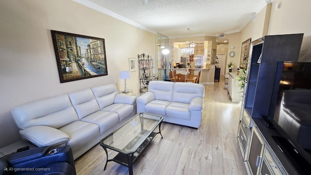 9587 Weldon Cir Unit B414, Tamarac, FL 33321 - living room featuring light wood-style floors, crown molding, and a textured ceiling