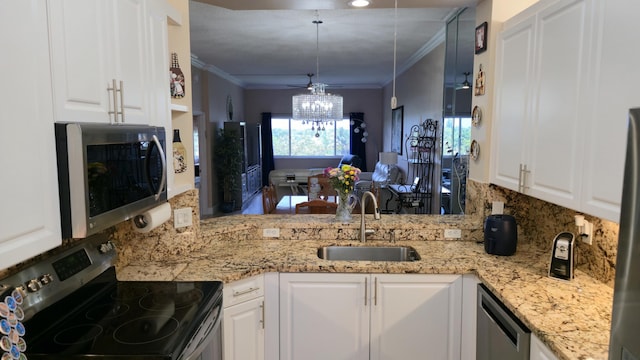 9587 Weldon Cir Unit B414, Tamarac, FL 33321 - kitchen featuring stainless steel appliances, decorative backsplash, a sink, white cabinets, and crown molding