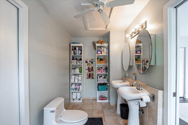 1117 Gopher Ridge Rd, Fort Pierce, FL 34982 - bathroom featuring toilet, a ceiling fan, a sink, and tile patterned flooring