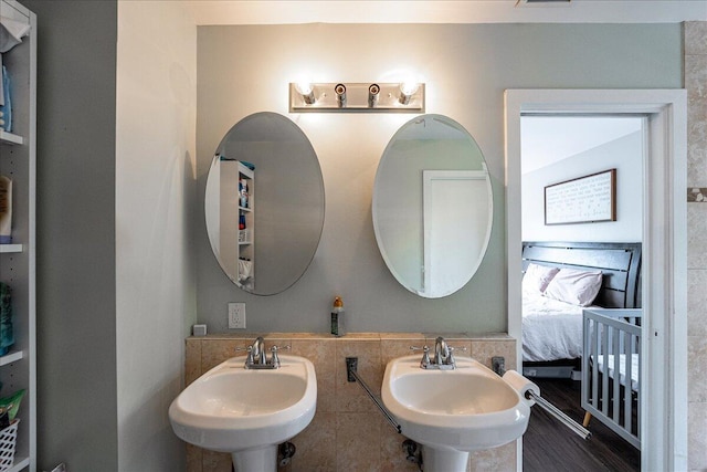 1117 Gopher Ridge Rd, Fort Pierce, FL 34982 - bathroom featuring a sink, ensuite bathroom, and tile walls