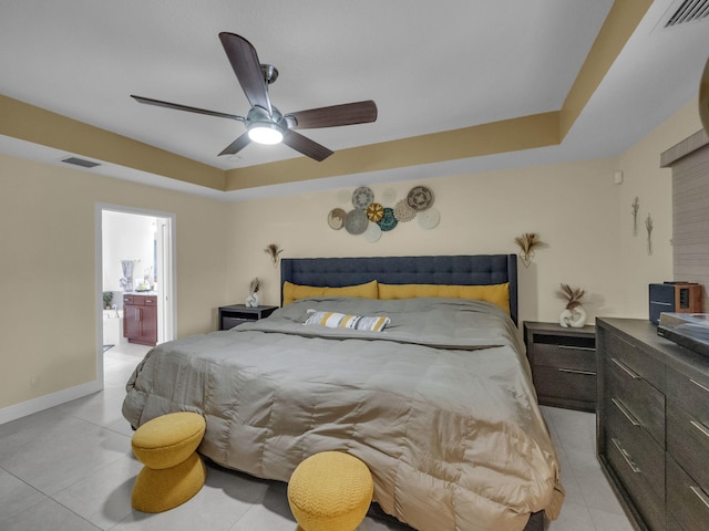 16430 71st Ln N, Loxahatchee, FL 33470 - bedroom with light tile patterned flooring, a raised ceiling, ensuite bath, ceiling fan, and baseboards