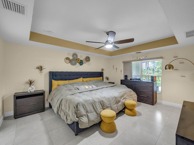 16430 71st Ln N, Loxahatchee, FL 33470 - bedroom featuring a tray ceiling, baseboards, ceiling fan, and light tile patterned floors