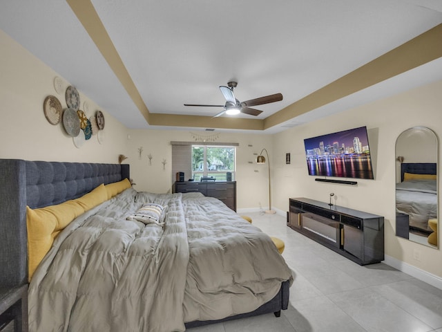 16430 71st Ln N, Loxahatchee, FL 33470 - bedroom with a tray ceiling, baseboards, tile patterned flooring, and a ceiling fan