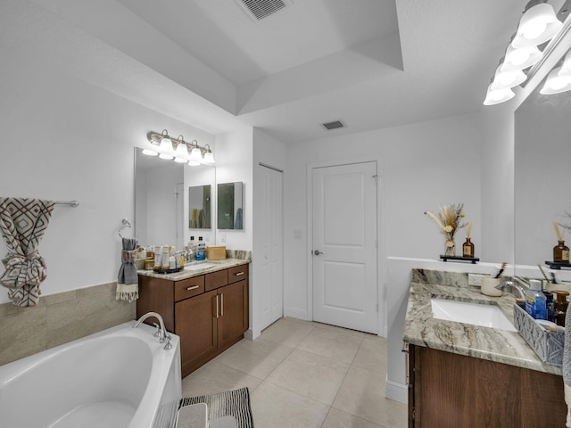 16430 71st Ln N, Loxahatchee, FL 33470 - full bathroom featuring two vanities, tile patterned flooring, a garden tub, and a raised ceiling