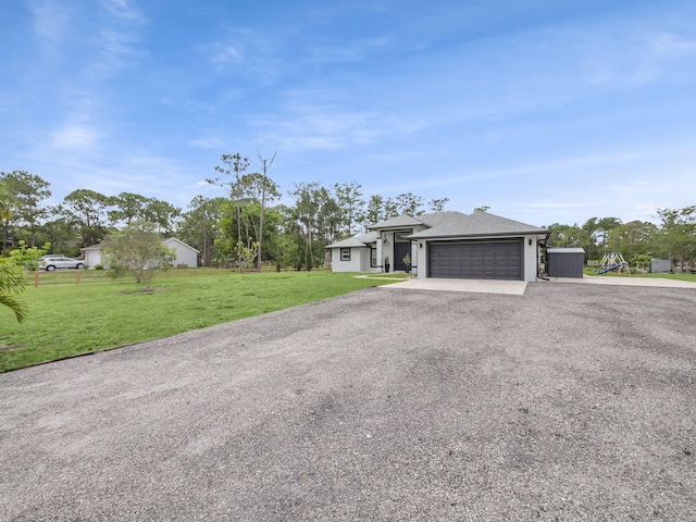 16430 71st Ln N, Loxahatchee, FL 33470 - view of front of house with gravel driveway and a garage