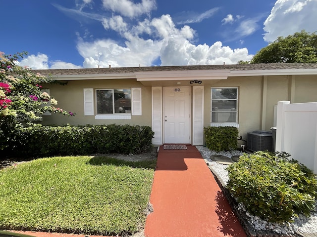 18856 Argosy Dr Unit C, Boca Raton, FL 33496 - doorway to property featuring stucco siding and cooling unit