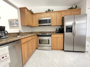 18856 Argosy Dr Unit C, Boca Raton, FL 33496 - kitchen featuring stainless steel appliances, a sink, light tile patterned flooring, and dark countertops