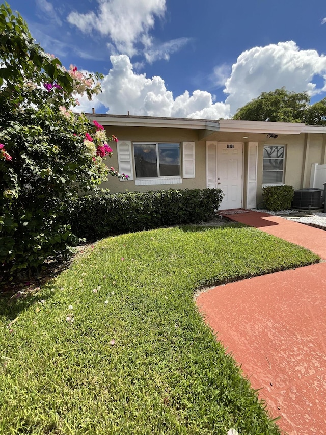 18856 Argosy Dr Unit C, Boca Raton, FL 33496 - ranch-style home featuring a front lawn, cooling unit, and stucco siding