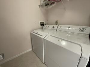 18856 Argosy Dr Unit C, Boca Raton, FL 33496 - washroom with separate washer and dryer, light tile patterned floors, and baseboards