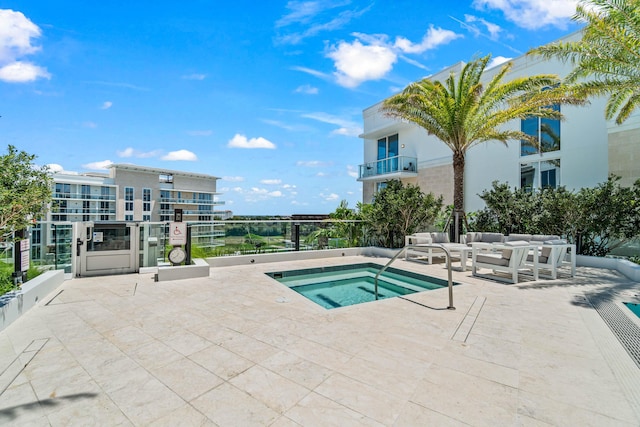 220 SE Mizner Blvd Unit 611, Boca Raton, FL 33432 - view of swimming pool featuring a community hot tub and an outdoor hangout area