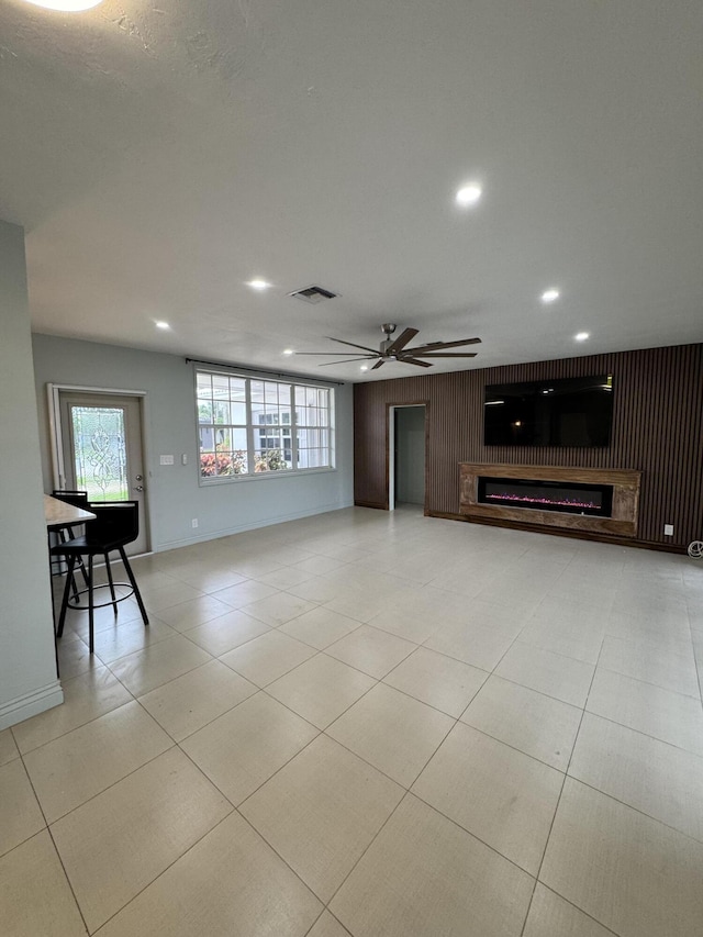 391 SE 15th Ave, Pompano Beach, FL 33060 - unfurnished living room featuring ceiling fan, a glass covered fireplace, plenty of natural light, recessed lighting, and baseboards