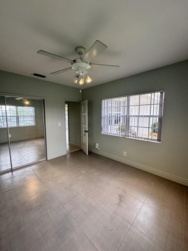 391 SE 15th Ave, Pompano Beach, FL 33060 - unfurnished bedroom featuring baseboards and a ceiling fan