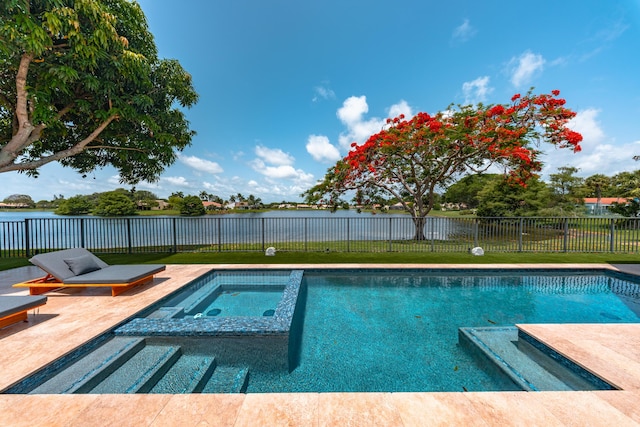 2407 SW 23rd Cranbrook Dr, Boynton Beach, FL 33436 - view of swimming pool with a water view, a fenced backyard, a pool with connected hot tub, and a patio