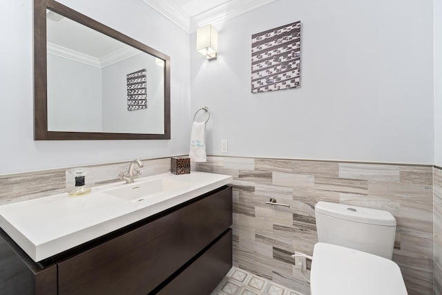 2407 SW 23rd Cranbrook Dr, Boynton Beach, FL 33436 - bathroom with tile walls, crown molding, toilet, vanity, and a wainscoted wall