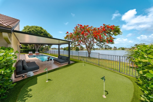 2407 SW 23rd Cranbrook Dr, Boynton Beach, FL 33436 - view of community with a putting area, a water view, a fenced backyard, a patio area, and a swimming pool