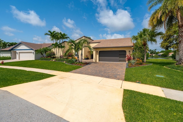 2407 SW 23rd Cranbrook Dr, Boynton Beach, FL 33436 - mediterranean / spanish home with driveway, stucco siding, a front lawn, and a garage