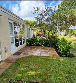 13725 Flora Pl Unit D, Delray Beach, FL 33484 - view of grassy yard featuring a patio