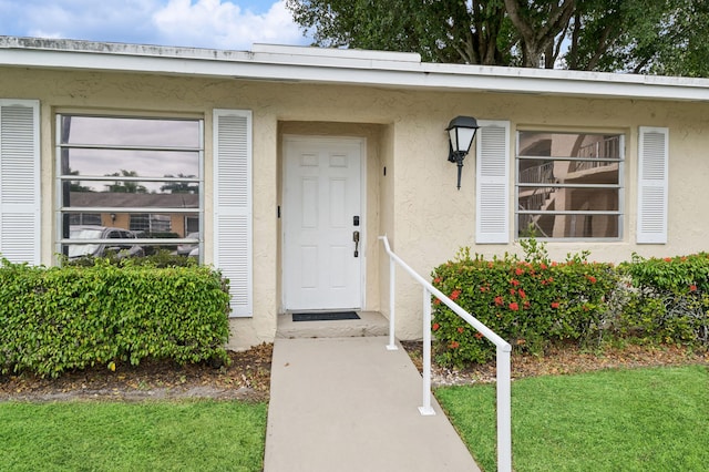 13725 Flora Pl Unit D, Delray Beach, FL 33484 - property entrance featuring stucco siding and a lawn