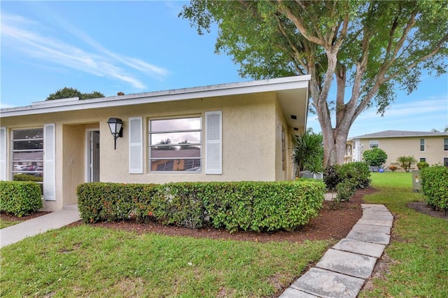 13725 Flora Pl Unit D, Delray Beach, FL 33484 - view of front of house featuring stucco siding and a front yard