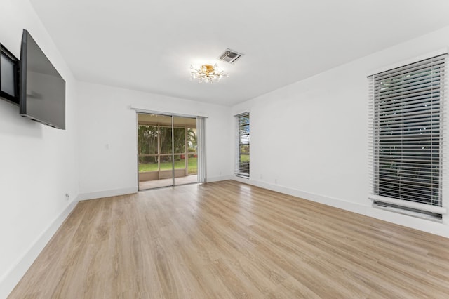 13725 Flora Pl Unit D, Delray Beach, FL 33484 - unfurnished living room with light wood-type flooring, a chandelier, and baseboards