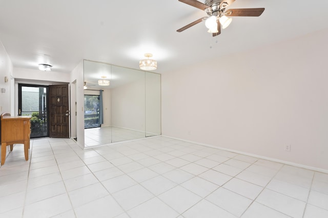 800 NW Fork Rd Unit 9-1, Stuart, FL 34994 - empty room with ceiling fan, light tile patterned floors, and baseboards