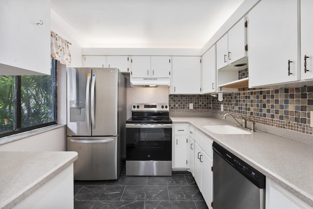 800 NW Fork Rd Unit 9-1, Stuart, FL 34994 - kitchen with appliances with stainless steel finishes, under cabinet range hood, a sink, white cabinets, and light countertops