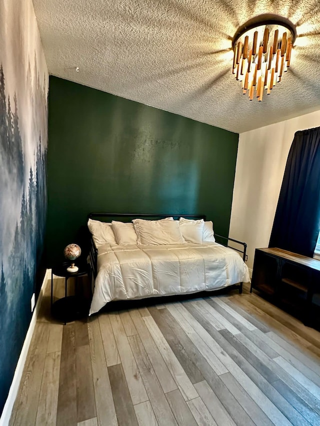 5690 Honeysuckle Dr, West Palm Beach, FL 33415 - bedroom with a textured ceiling, wood-type flooring, and a chandelier