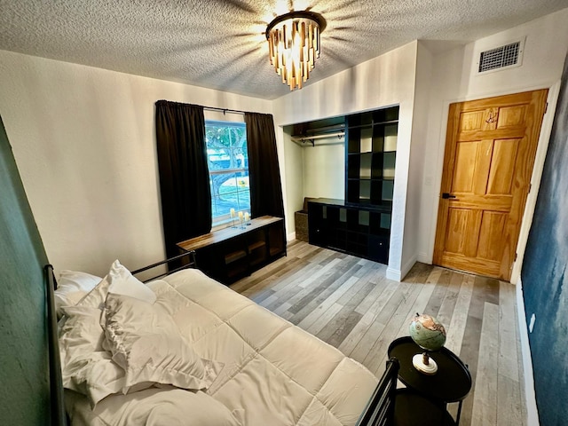 5690 Honeysuckle Dr, West Palm Beach, FL 33415 - bedroom featuring light wood-style floors, a textured ceiling, and baseboards