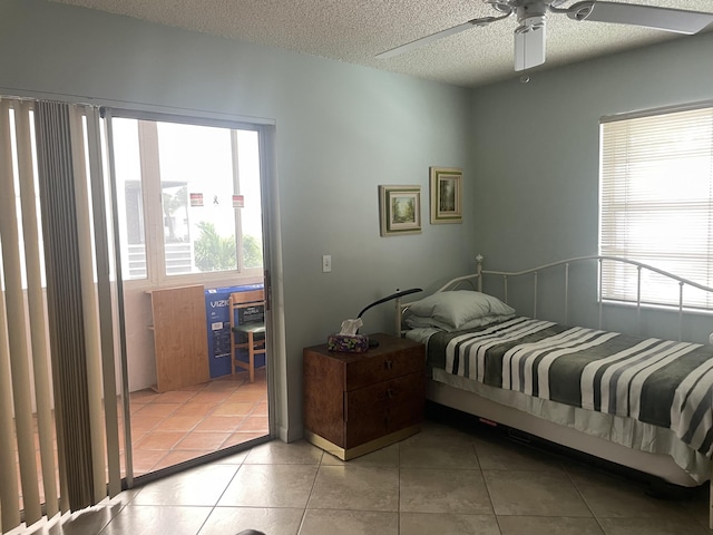 173 Normandy D, Delray Beach, FL 33484 - bedroom with a textured ceiling, light tile patterned flooring, and a ceiling fan
