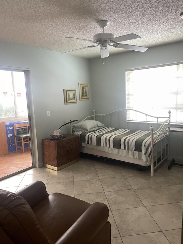 173 Normandy D, Delray Beach, FL 33484 - bedroom featuring light tile patterned floors, a ceiling fan, and a textured ceiling