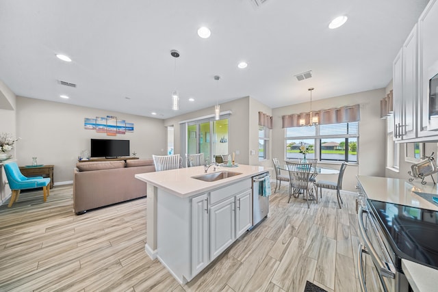 11187 SW Lake Park Dr, Port Saint Lucie, FL 34987 - kitchen featuring appliances with stainless steel finishes, a sink, light countertops, light wood-type flooring, and baseboards