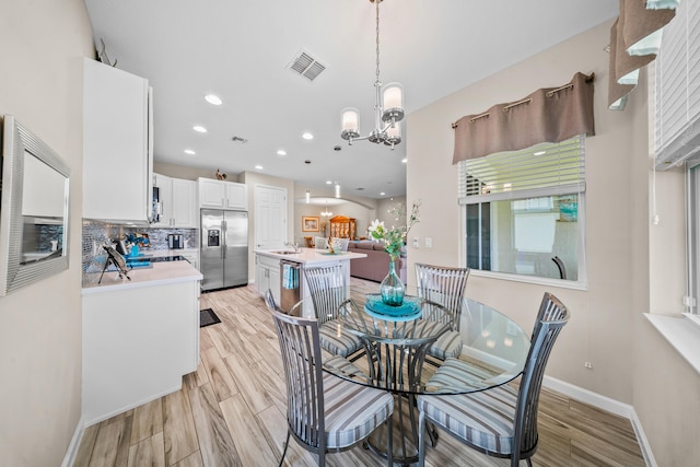 11187 SW Lake Park Dr, Port Saint Lucie, FL 34987 - dining area featuring a chandelier, light wood-style flooring, baseboards, and recessed lighting